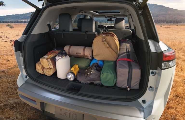 The open trunk of a 2024 Nissan Pathfinder packed with cargo